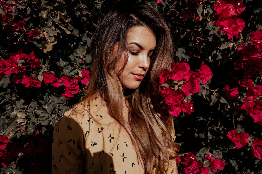 Sarah among deep red bougainvillea