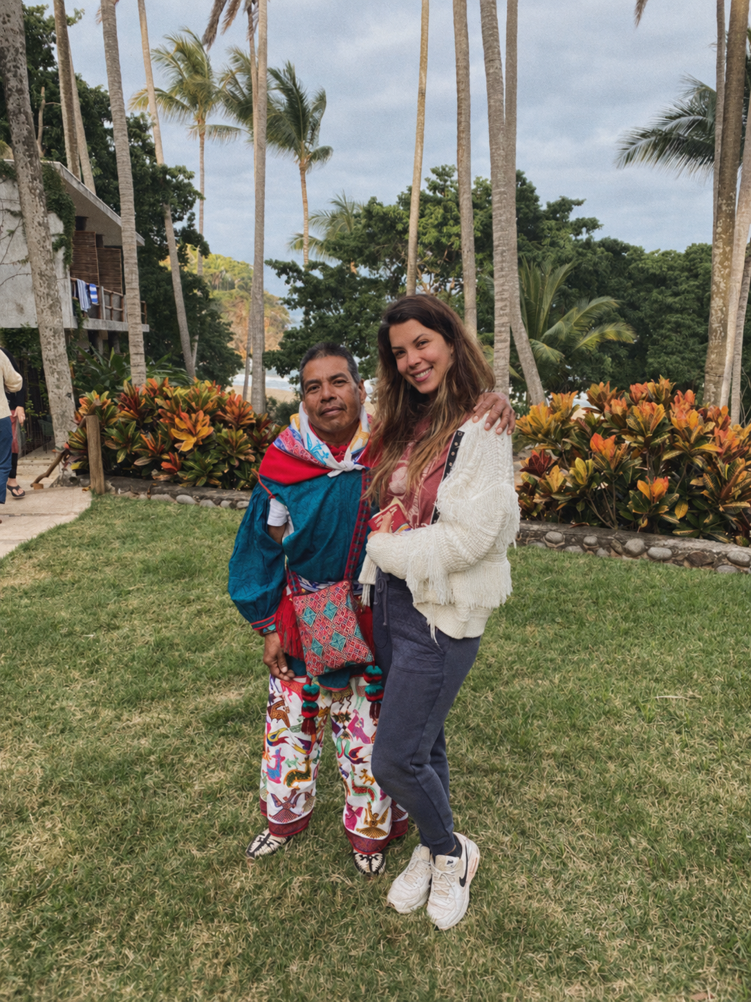 Sarah with a teacher in a tropical landscape