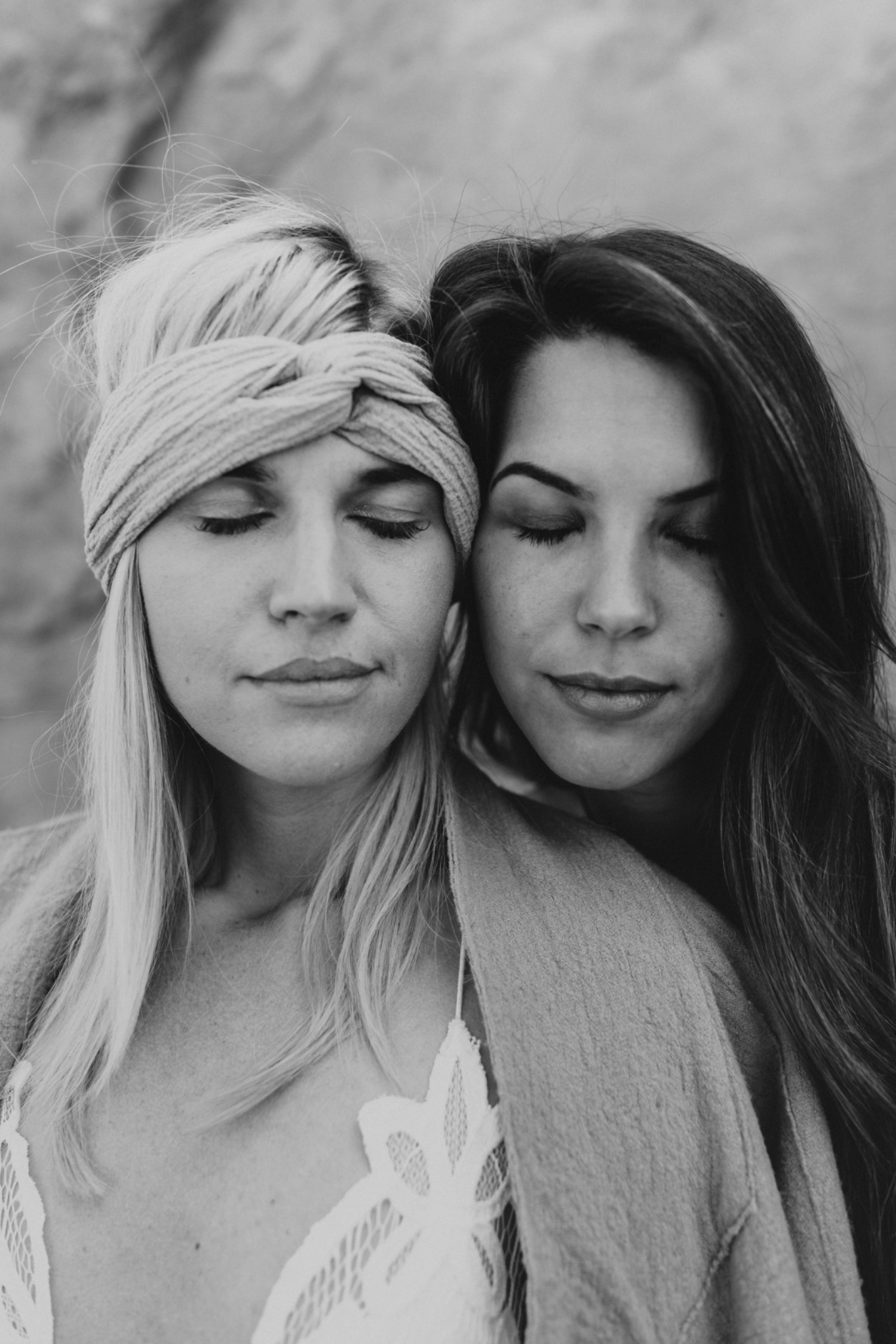 Two women sharing a quiet moment with their eyes closed